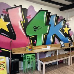 the logo of J4K on a wall in a graffiti style